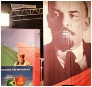 Dilma palestrando com a imagem de Lenin ao fundo