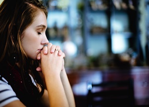 Oração - Menina rezando na Igreja.